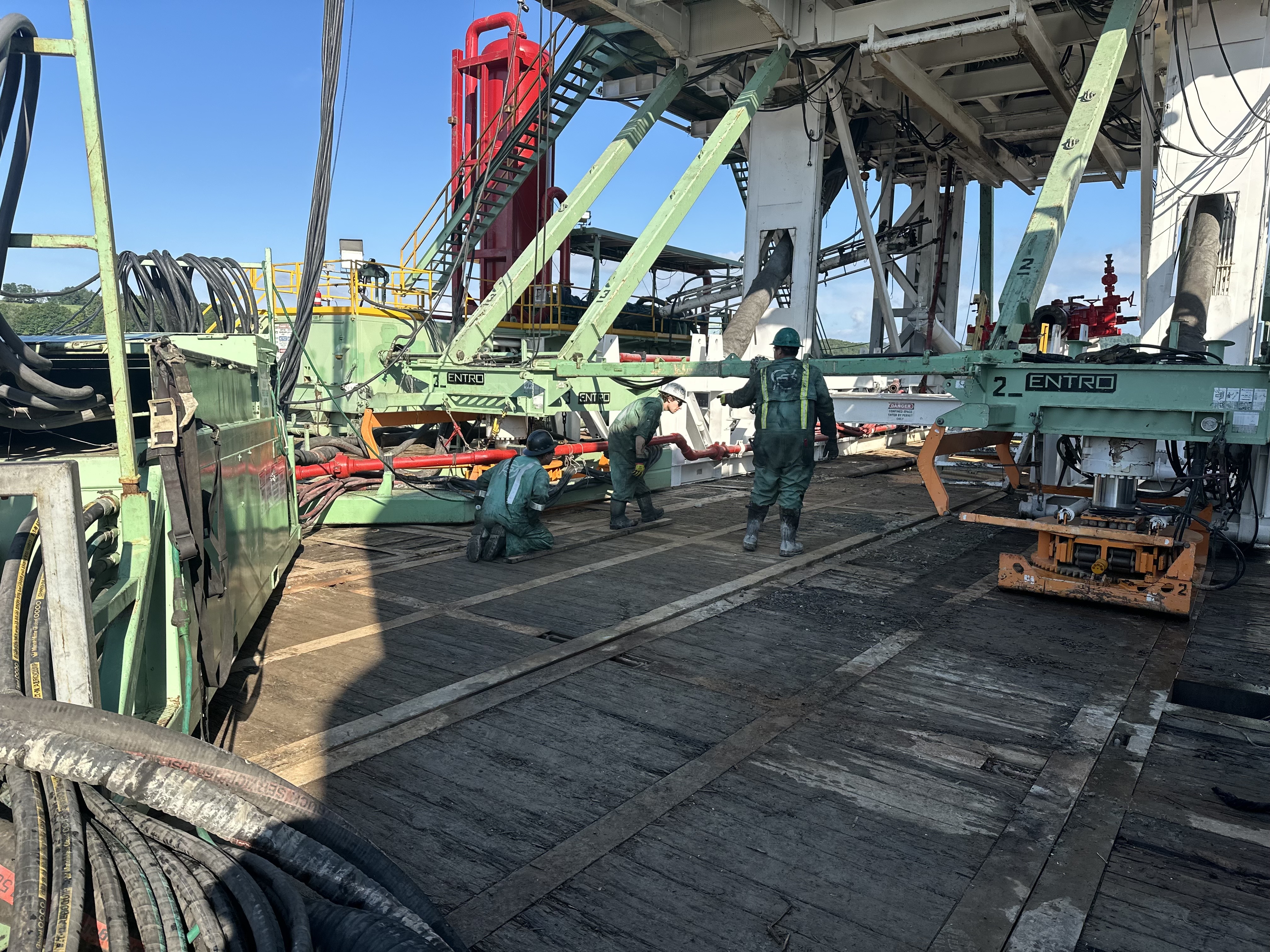 Work site with numerous trucks, containers, and a mobile crane